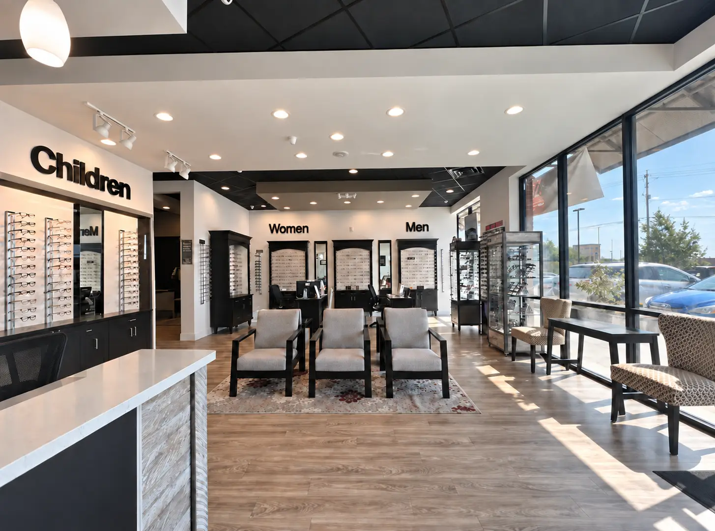 The optical floor at InSight EyeCare in Cibolo: frame displays along the walls under Children, Women and Men signs, a seating area in the middle of the room, and tall windows running down the right-hand side.